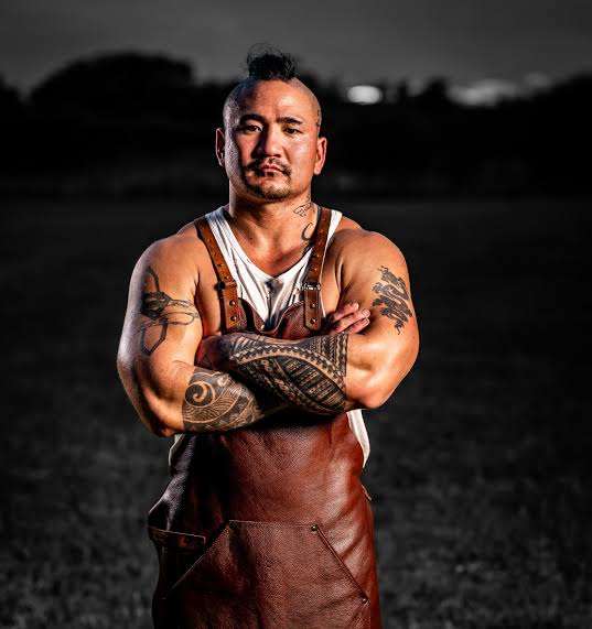 Stephen Kina, pitmaster of 406 BBQ, standing in his leather apron